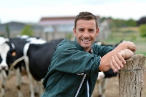 15694375-herdsman-standing-in-front-of-cattle-in-farm